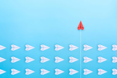 Group Of White Paper Plane In One Direction And One Red Paper Pl